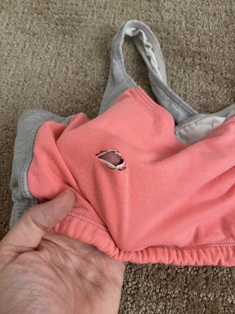 hole cut in sports bra for flange
