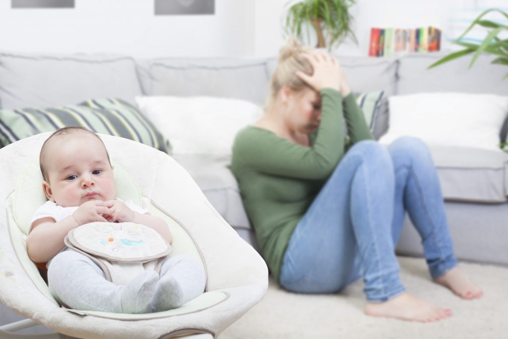 stressed out mom next to baby