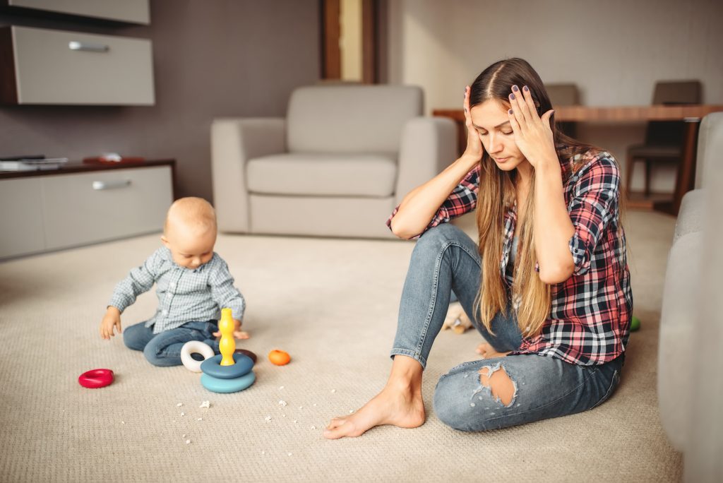 mom with hands on head by baby