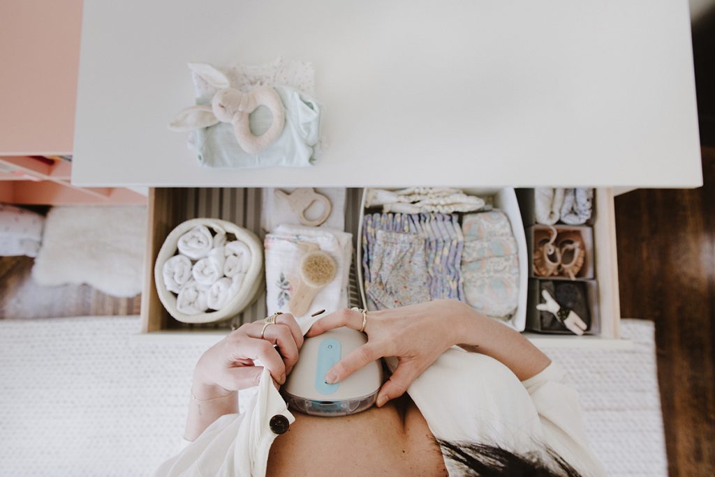 woman putting willow breast pump into shirt