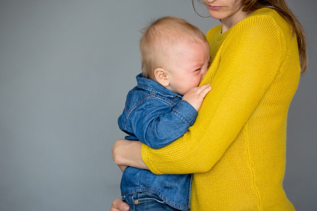 baby crying into mom's chest