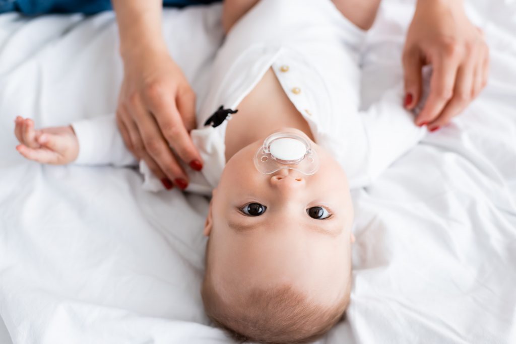 upside down baby with pacifier