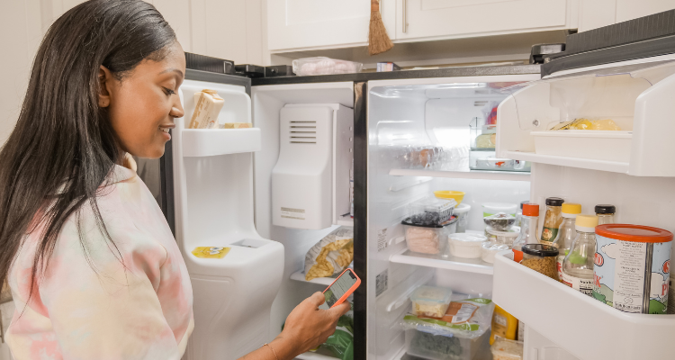 woman looking into fridge