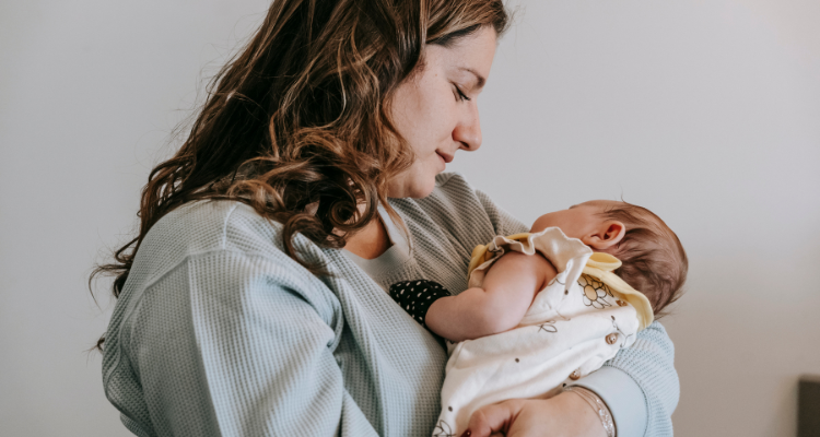 baby breastfeeding with mom