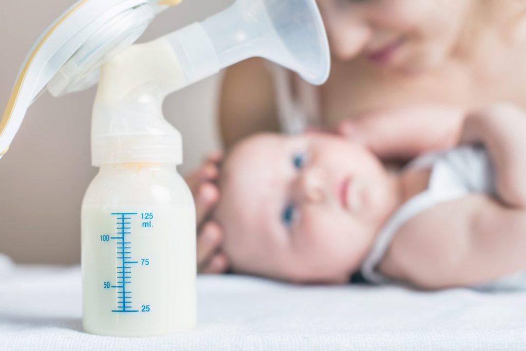 baby looking at a bottle. 