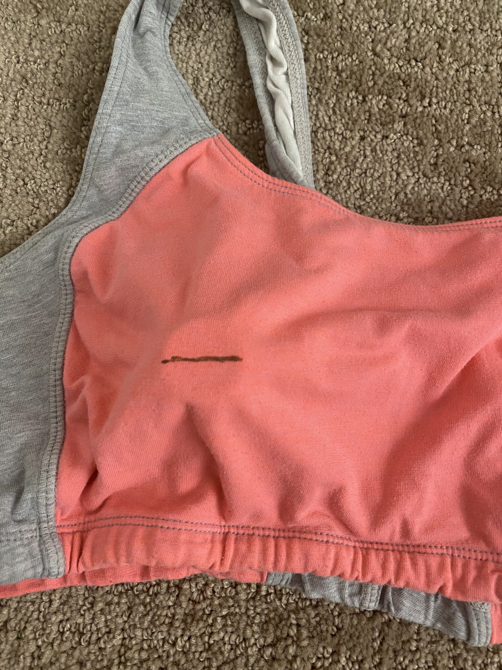 line drawn on top of sports bra to show where to cut