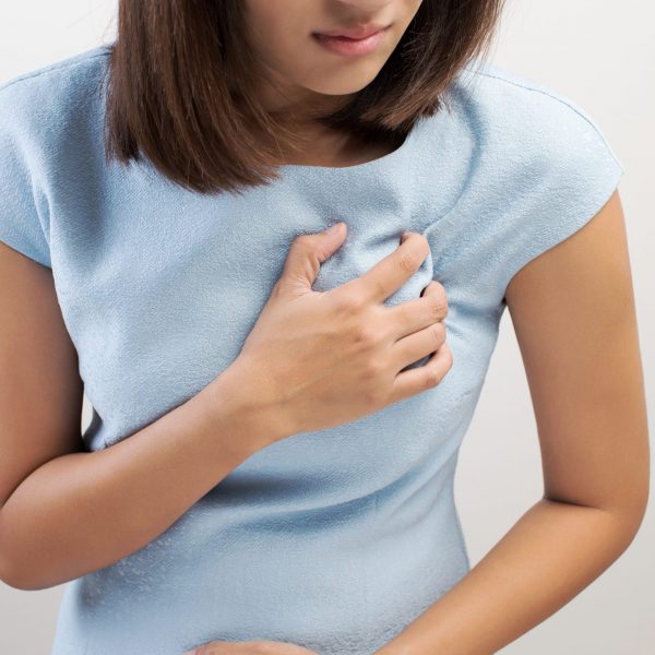 Woman is clutching her chest, acute pain possible Heart attack